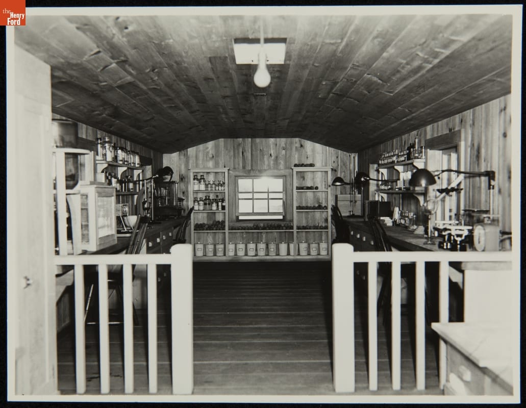 Wood-paneled room with walls lined with tables and equipment