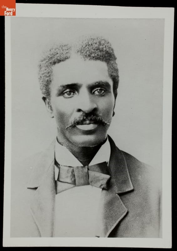 Portrait of Black man with mustache wearing jacket and tie