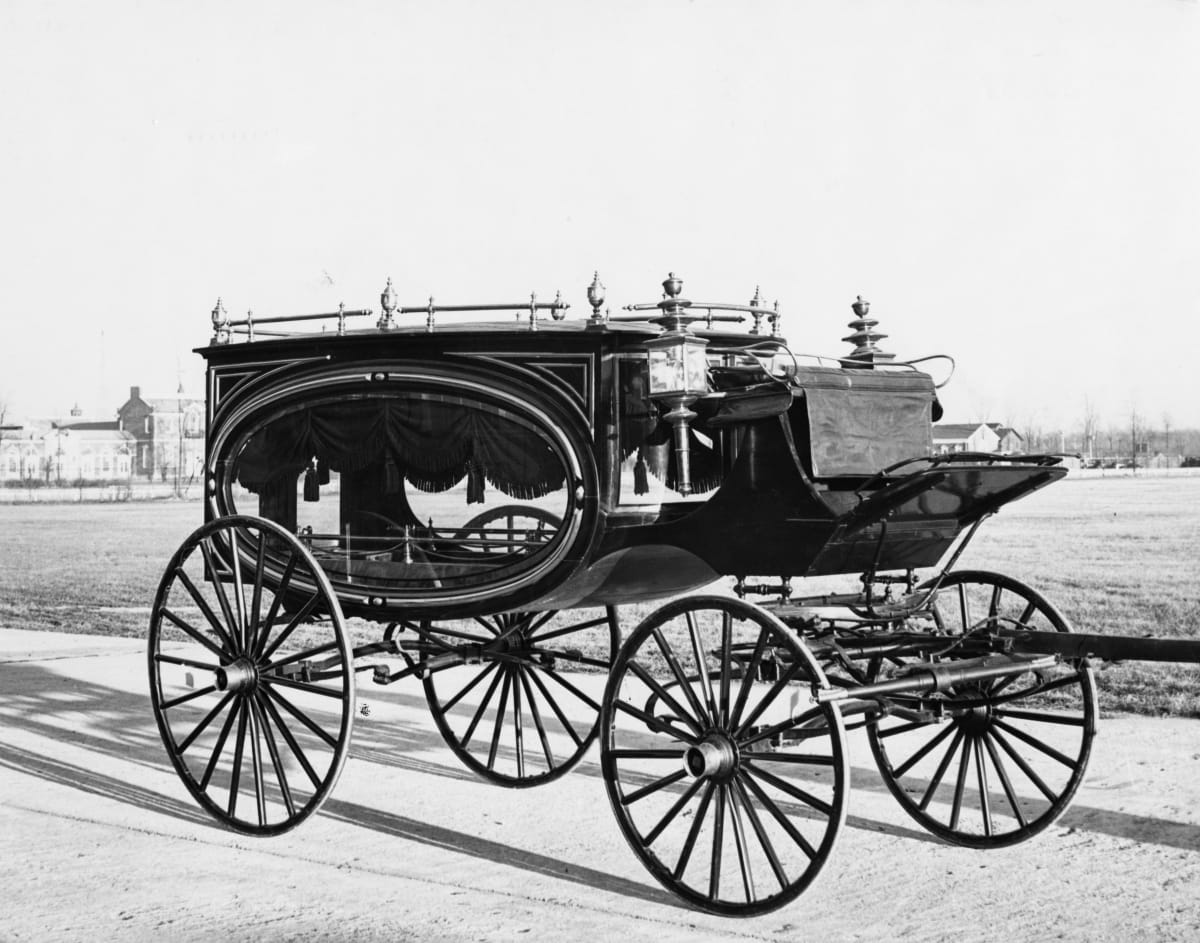 Hearse, circa 1875 Carriage with large oval window topped with curtain on side