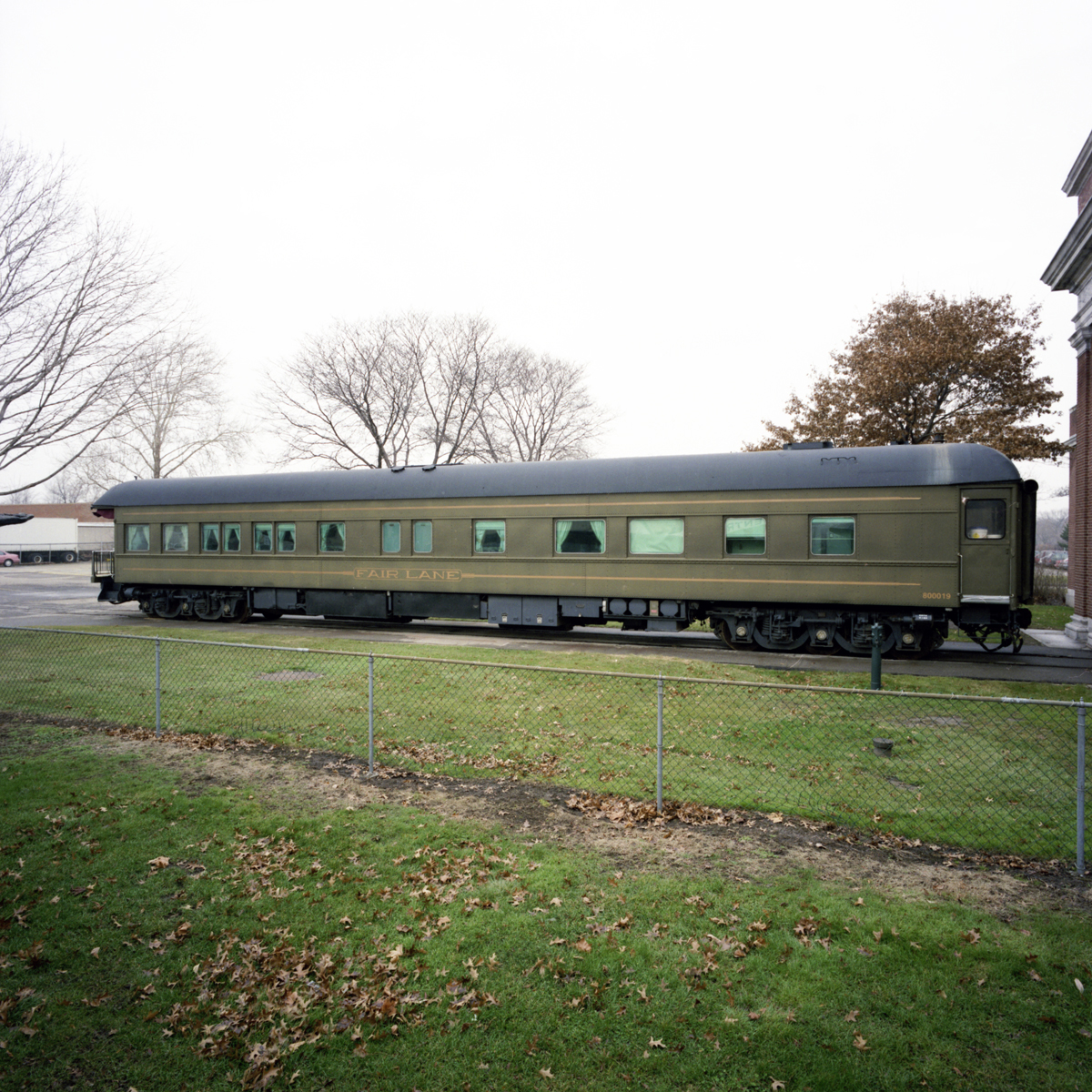 Henry Ford's Private Railroad Car "Fair Lane," 1921 Long, army-green rail car on tracks in a field