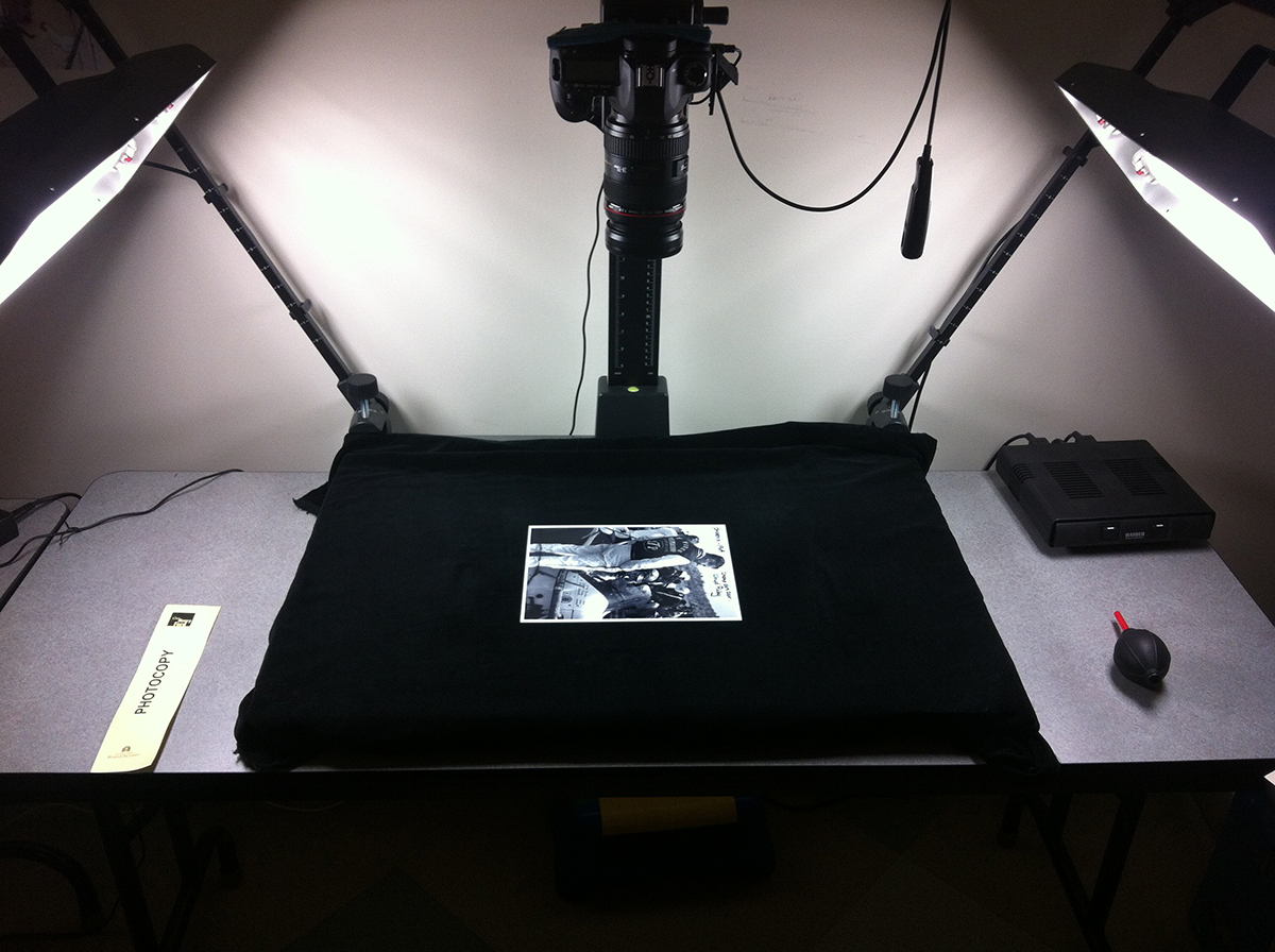 Rapid Capture workstation Photograph lying on black fabric with lights on either side and a camera pointed downward at it