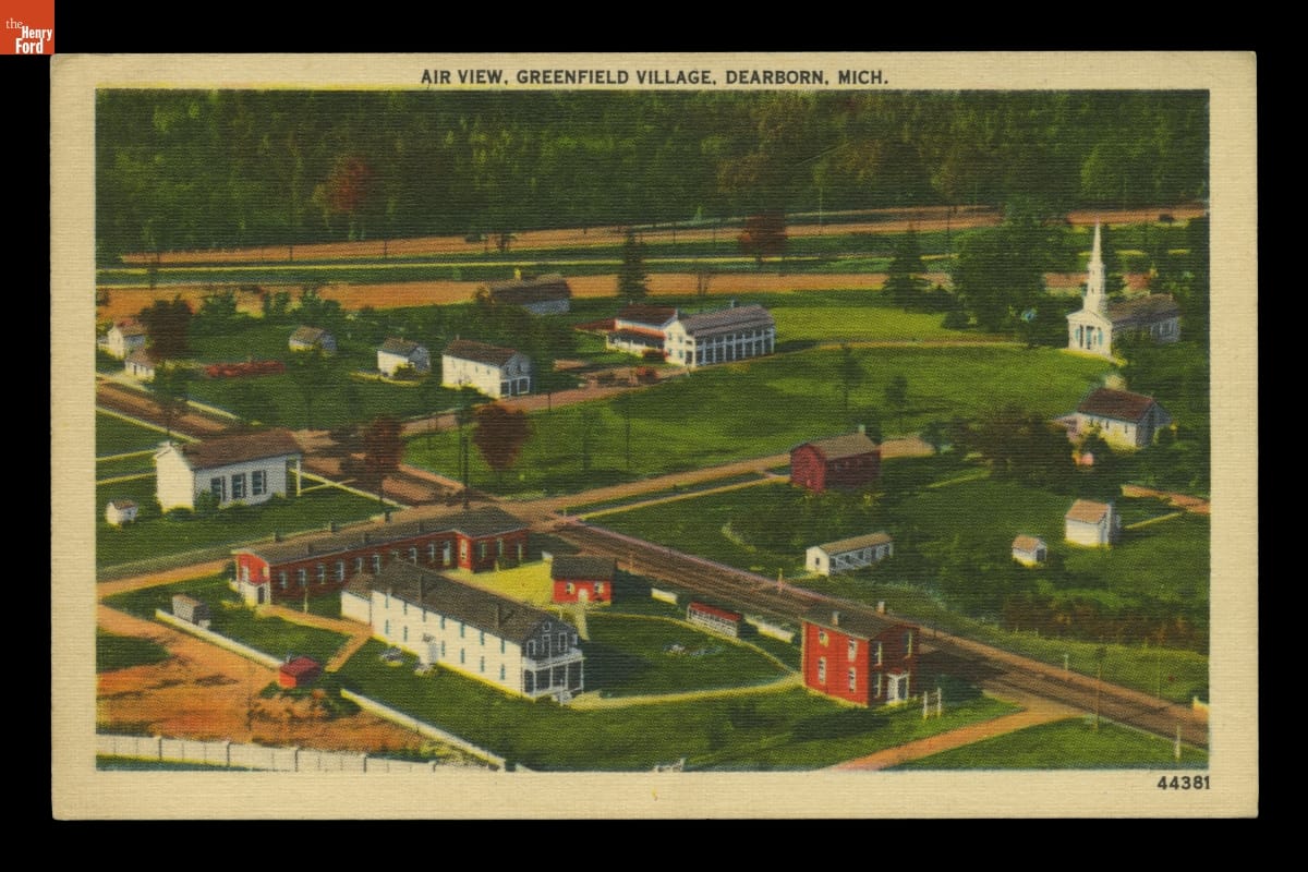 Postcard with image of buildings, greenspace, and roads
