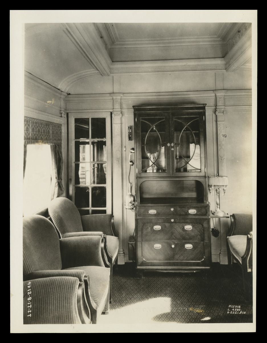 Interior of Henry Ford's Private Railroad Car, "Fair Lane," June 22, 1921 Interior of room with two upholstered chairs and dresser with cabinet above