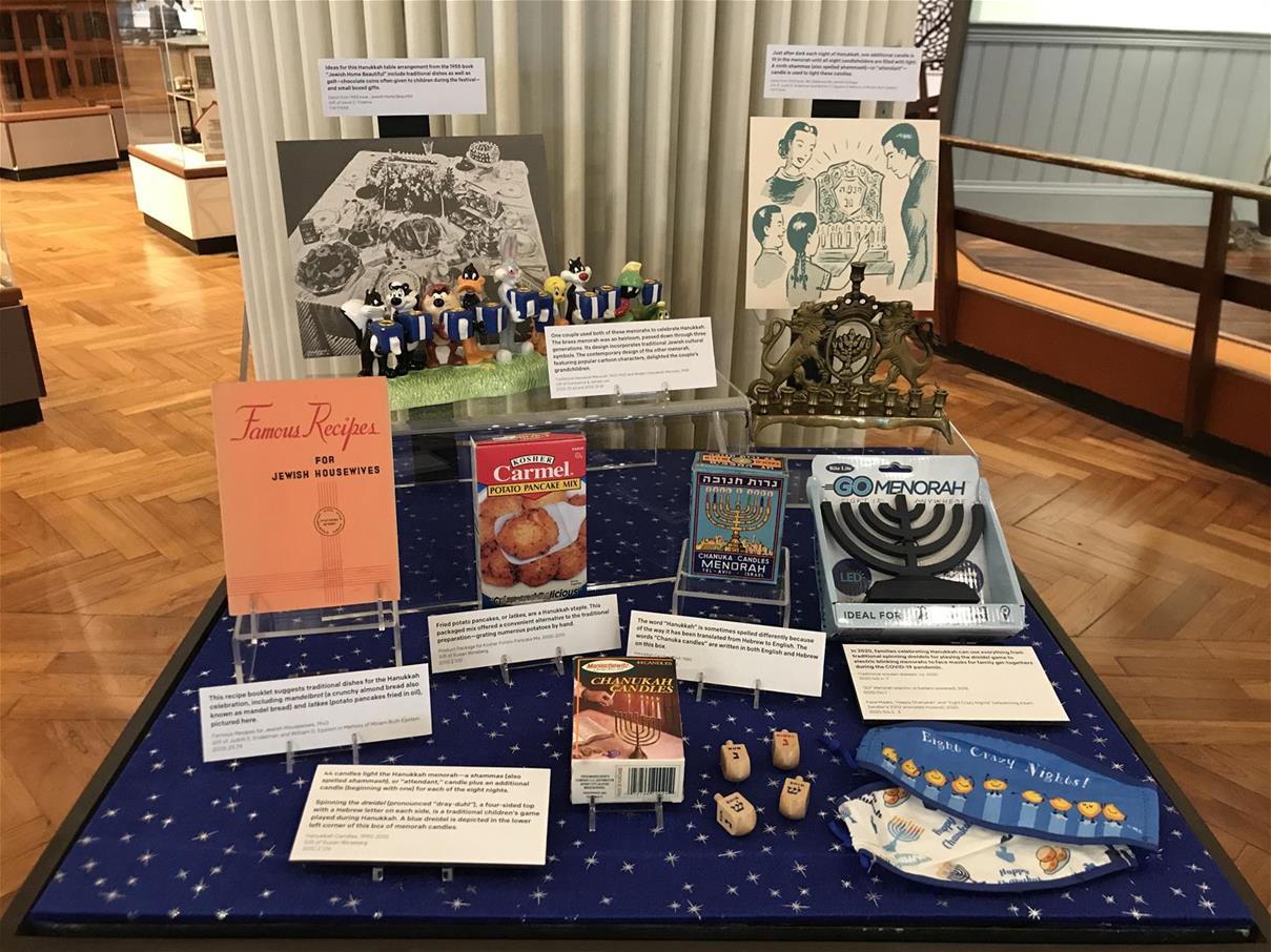 Celebrating the Jewish Holiday of Hanukkah exhibit in Henry Ford Museum Exhibit case holding various items and textual cards