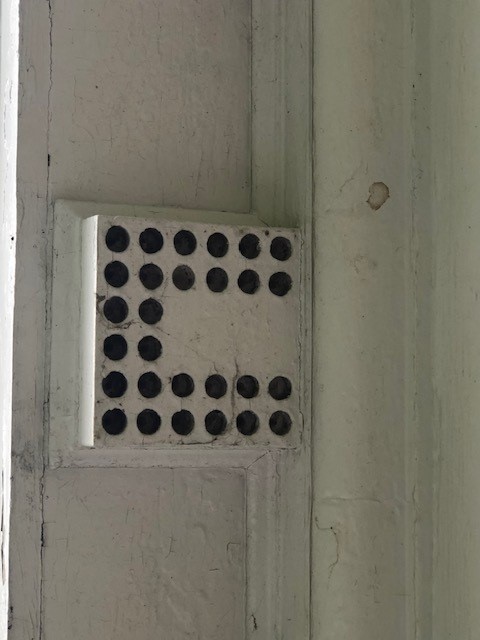 Mutule on the Webster House Architectural element of white box with round holes in a "U" pattern in it