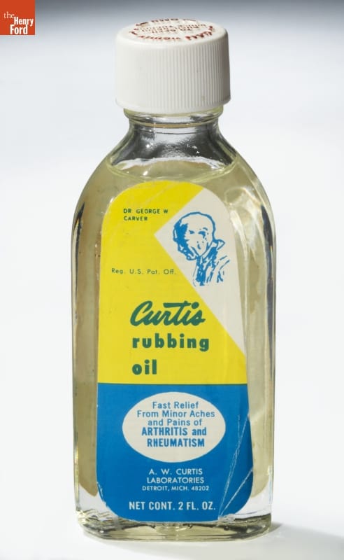 Curtis Rubbing Oil, circa 1987 Bottle with clear liquid and yellow and blue label with text and image of man's profile