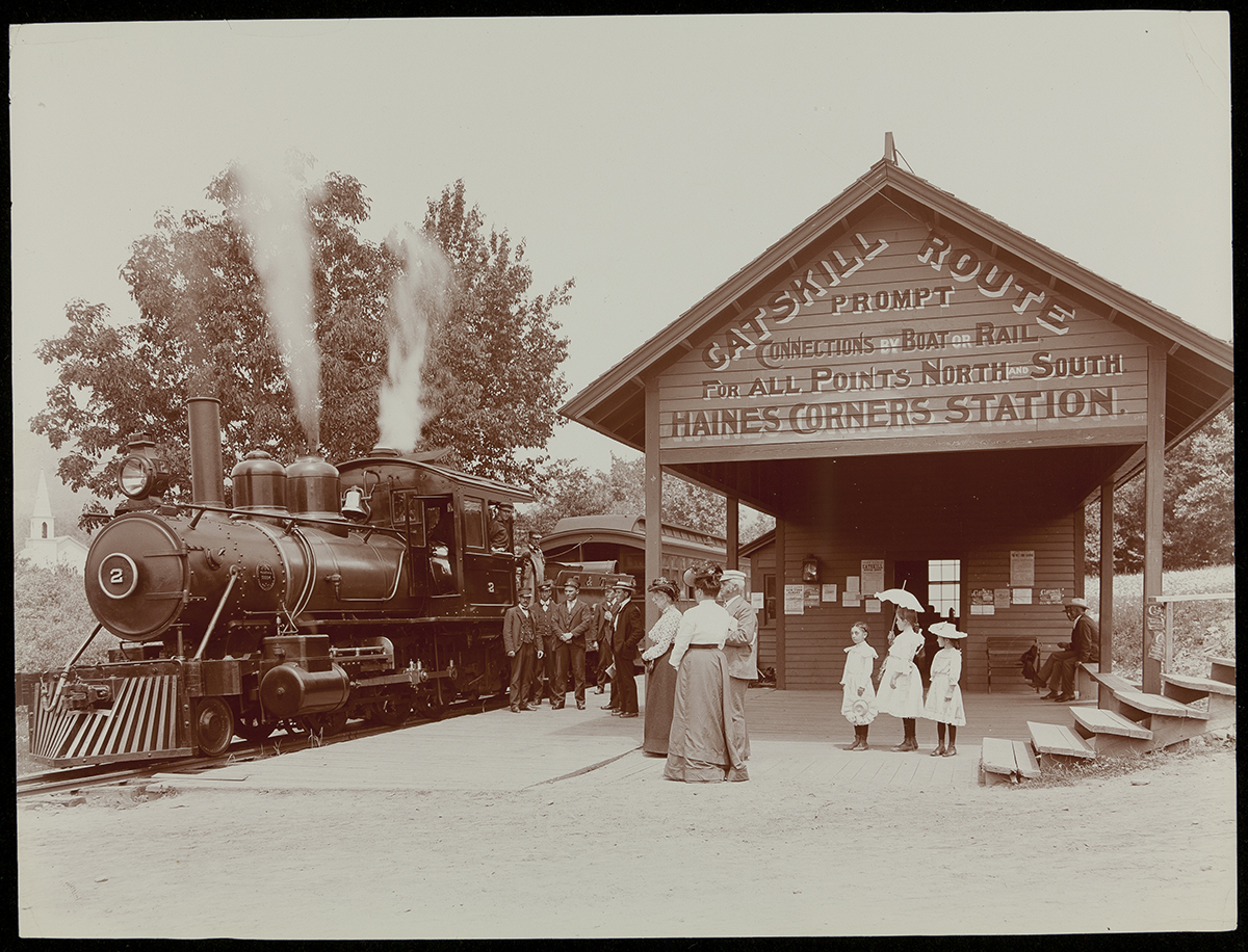 Railway Station at Haines Corners, Catskill Mountains, New York, circa 1902 Photo of train with steam coming from it at tentpole-like station with a number of people standing around