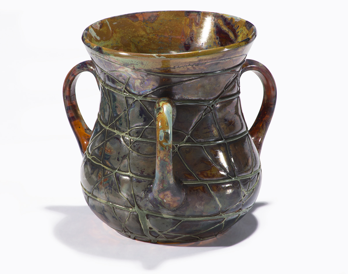 Short, wide vase in shades of brown with inscribed pattern of lines and three handles