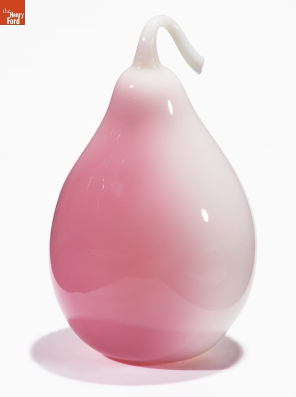 Glass pear with white color on one side morphing to pink on the other