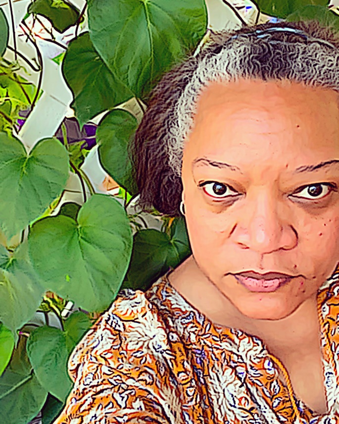Chawne Kimber, Easton, Pennsylvania Medium-dark-skinned woman wearing print top next to a trellis with large-leafed ivy