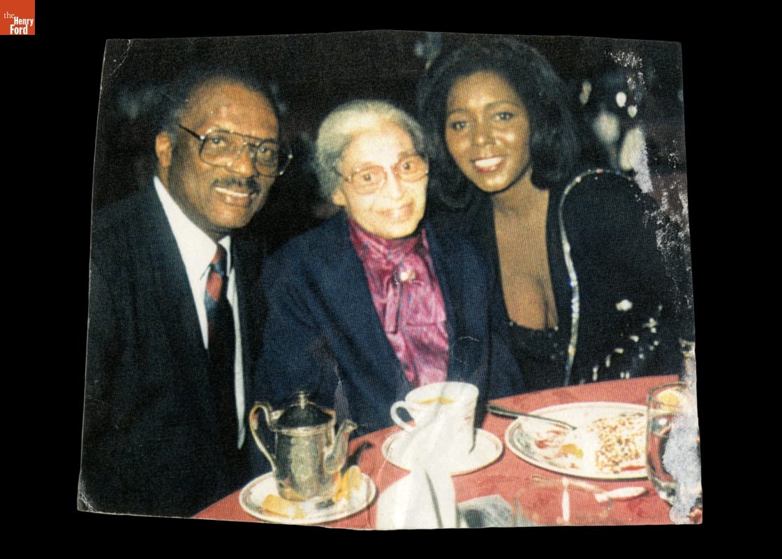 Rosa Parks with Curt and Judy Flood at a Dinner Event, 1994 Three formally-dressed people smile and pose for the camera at a dining table