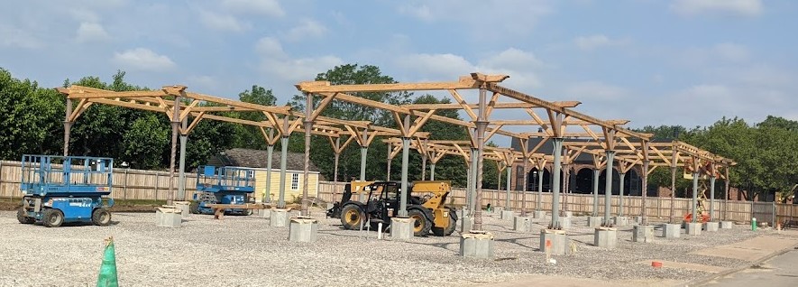 Photo of construction site with thin columns and rudimentary frame above them