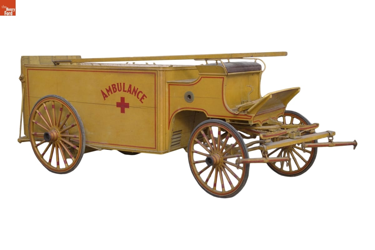 Veterinary Ambulance, circa 1900 Boxy low yellow wagon with red pinstriping, text "AMBULANCE," and a red cross on the side