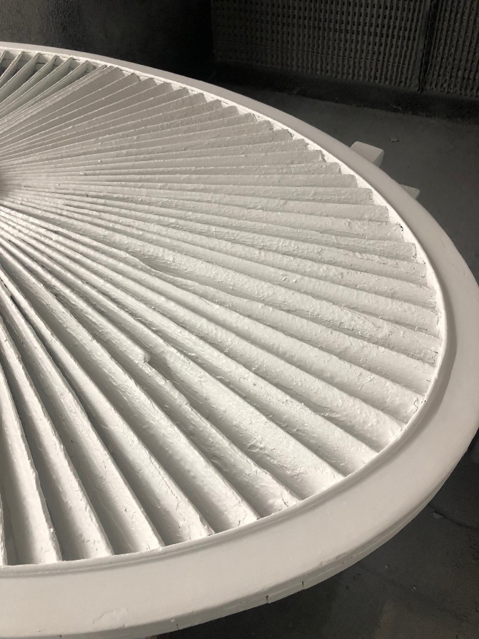 Decorative ellipse from the front pediment of the Noah Webster Home Close-up of round wooden architectural element with fan-shaped tines