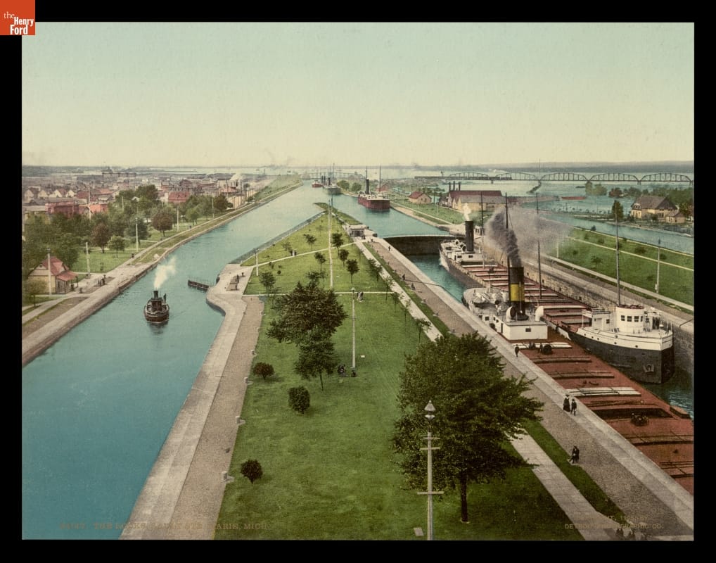 Large ships travel through narrow canals with locks
