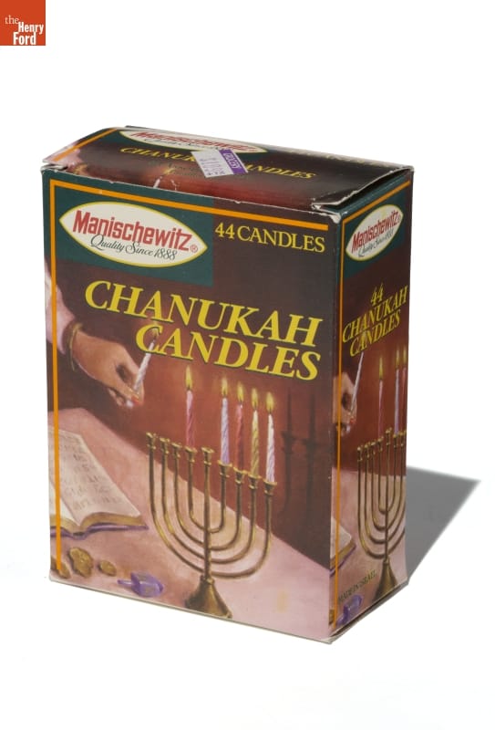 Box with image of hand lighting candles on a menorah, plus text