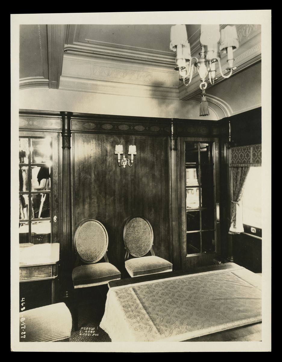 Interior of room with wood paneling, arched ceiling, and furniture
