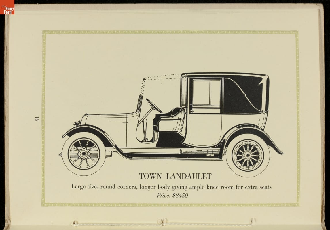 Illustration of boxy car with open driver's seat; contains text