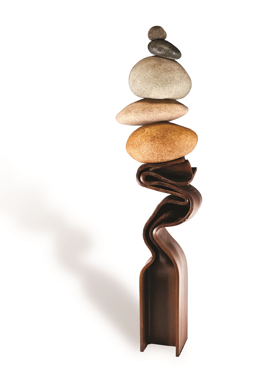 Artwork by Joshua Wojick Five variously colored rounded rocks balance on top of each other atop what seems to be a melted and serpentine metal beam