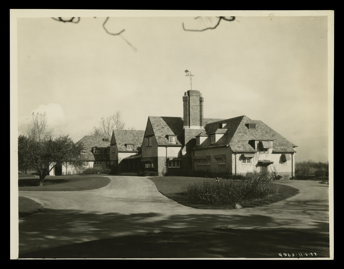 Two-story Tudor building with circular driveway