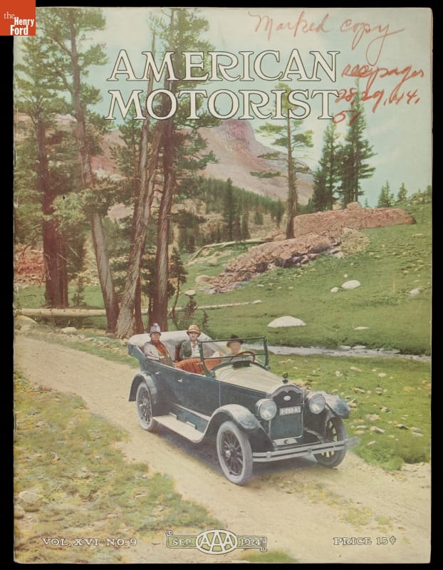 Four people in blue car on road through greenspace with trees and mountains in the background; also contains text
