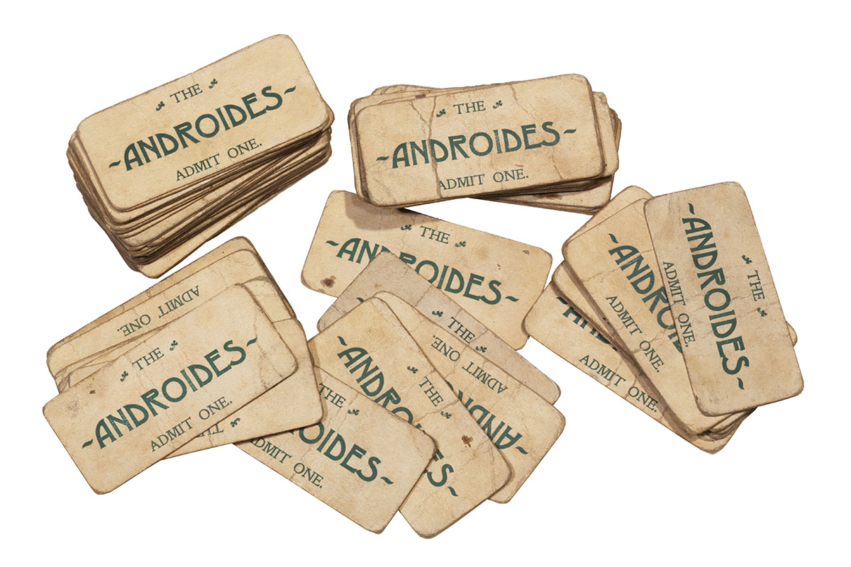 Beige tickets with words "THE ANDROIDES ADMIT ONE" in decorative font