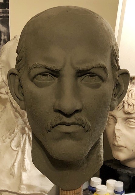 Head of man with receding hairline, mustache