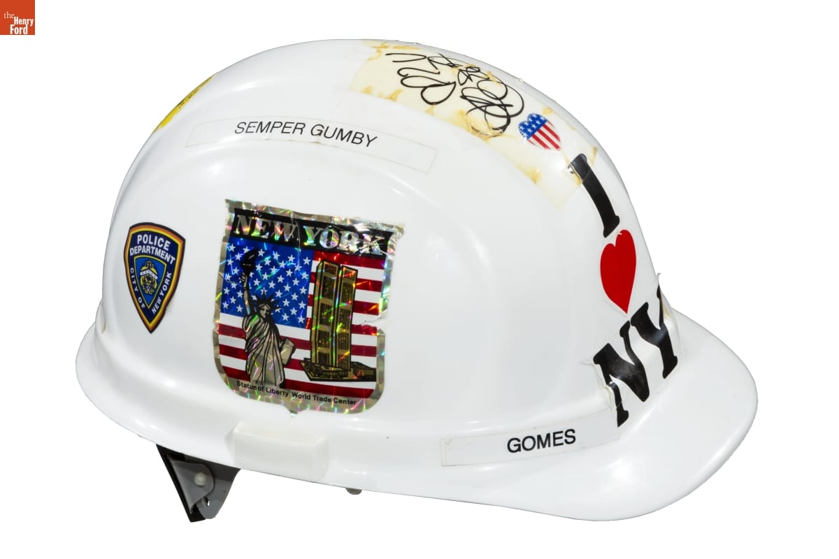 Hard Hat, Worn by Gerald Gomes While on Assignment at Ground Zero, September 2001 White hard hat with text, decals, and handwriting on it