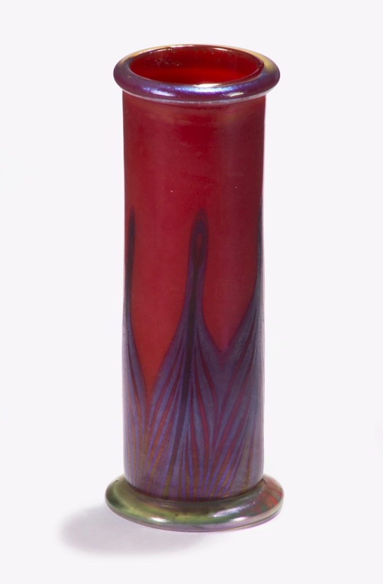 Thin red glass vase with "peacock feather" pattern in muted blues