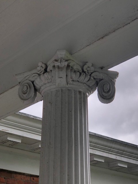 Architectural detail of column on rear portico of the Noah Webster Home Cornice of white column from underneath