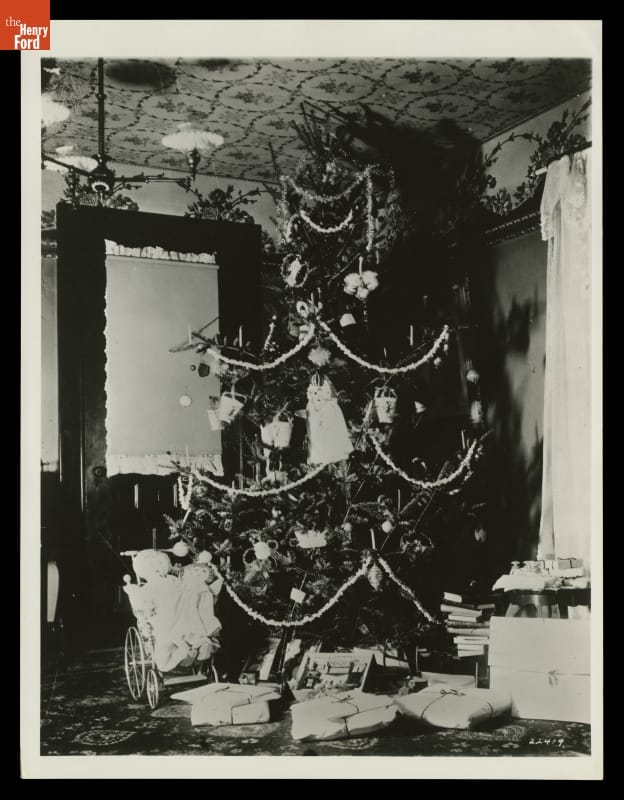Wright Home Parlor Decorated for Christmas, Original Site, Dayton, Ohio, circa 1900 Decorated Christmas tree in corner of room with wrapped and unwrapped items underneath