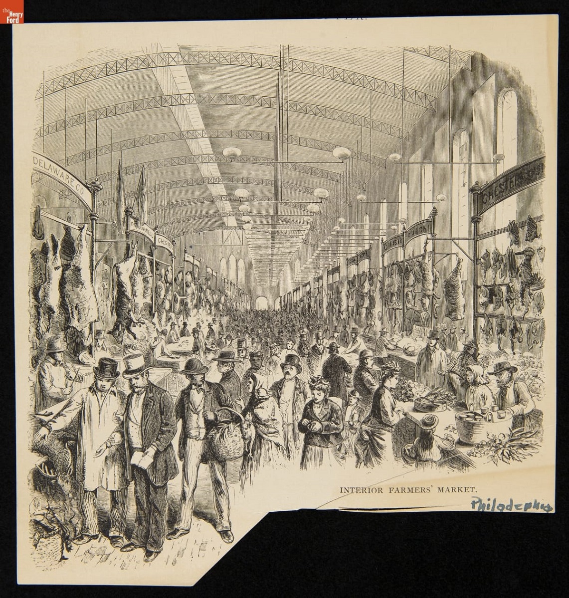 Interior of large building, crowded with people in large aisle with goods displayed on either side