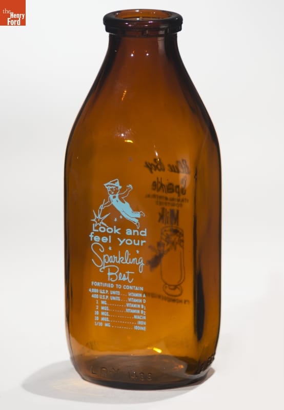 Brown bottle with blue text and image of boy in overalls with Peter Pan-type hat