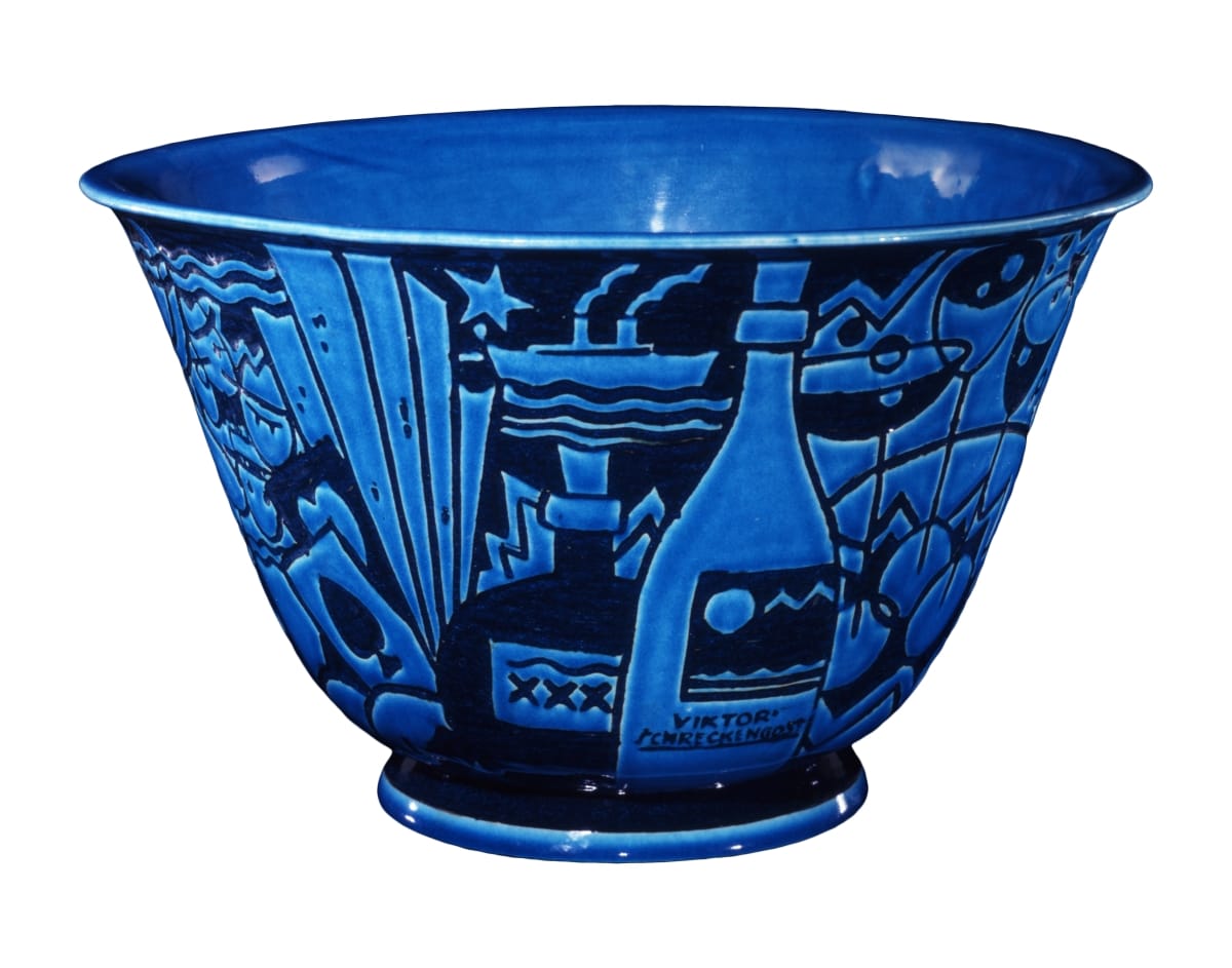 Bowl in two shades of blue depicting a champagne bottle and ship, among other decorative elements