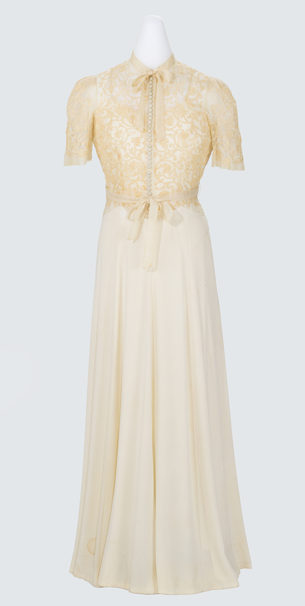 White or beige dress with short-sleeved lace top and long, slim skirt