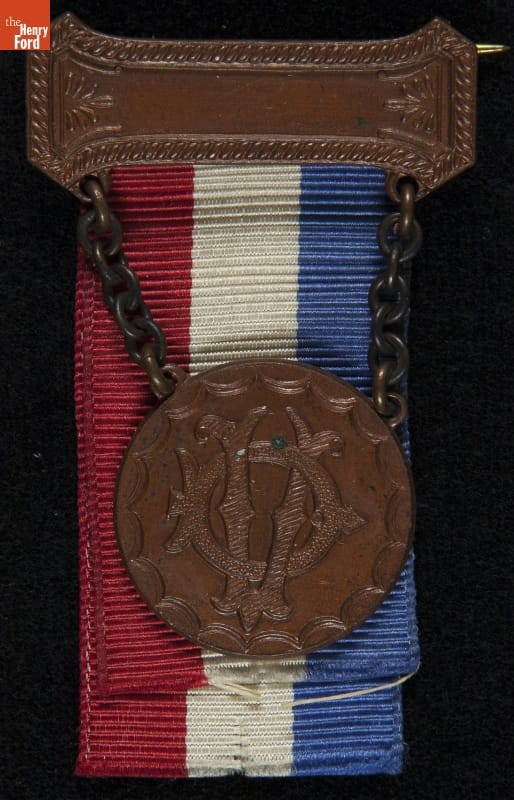 Daughters of Union Veterans of the Civil War Membership Badge, circa 1900 Metal (?) and fabric badge with red, white, and blue stripes and intertwined letters