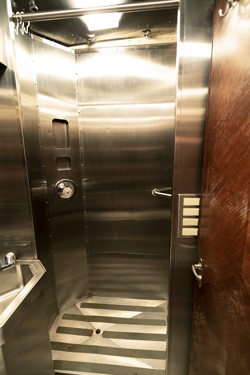 Stainless steel shower area with sink outside