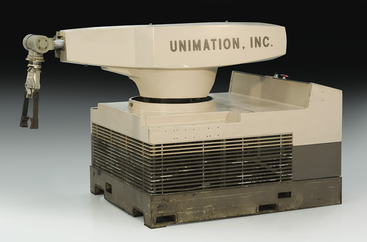 Robot, First Unimate Robot Ever Installed on an Assembly Line, 1961 Large, squat beige robot with a swing arm and text "UNIMATION, INC." on side