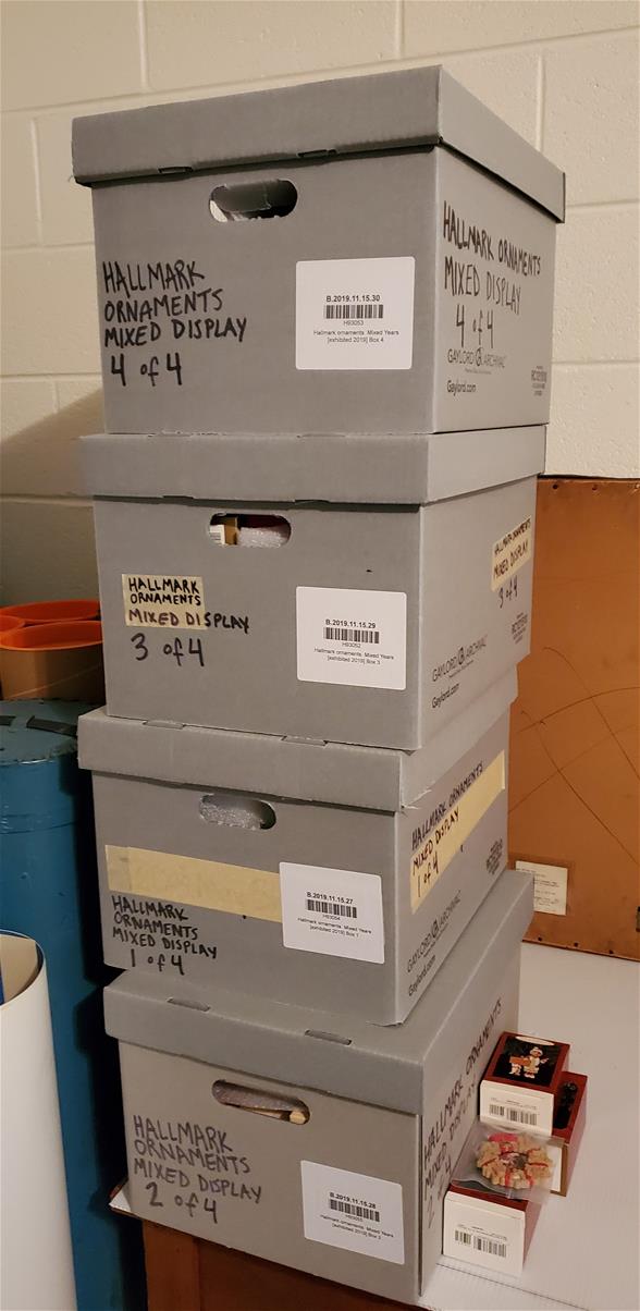 Barcoded boxes ready to be palletized. Four gray boxes in a stack