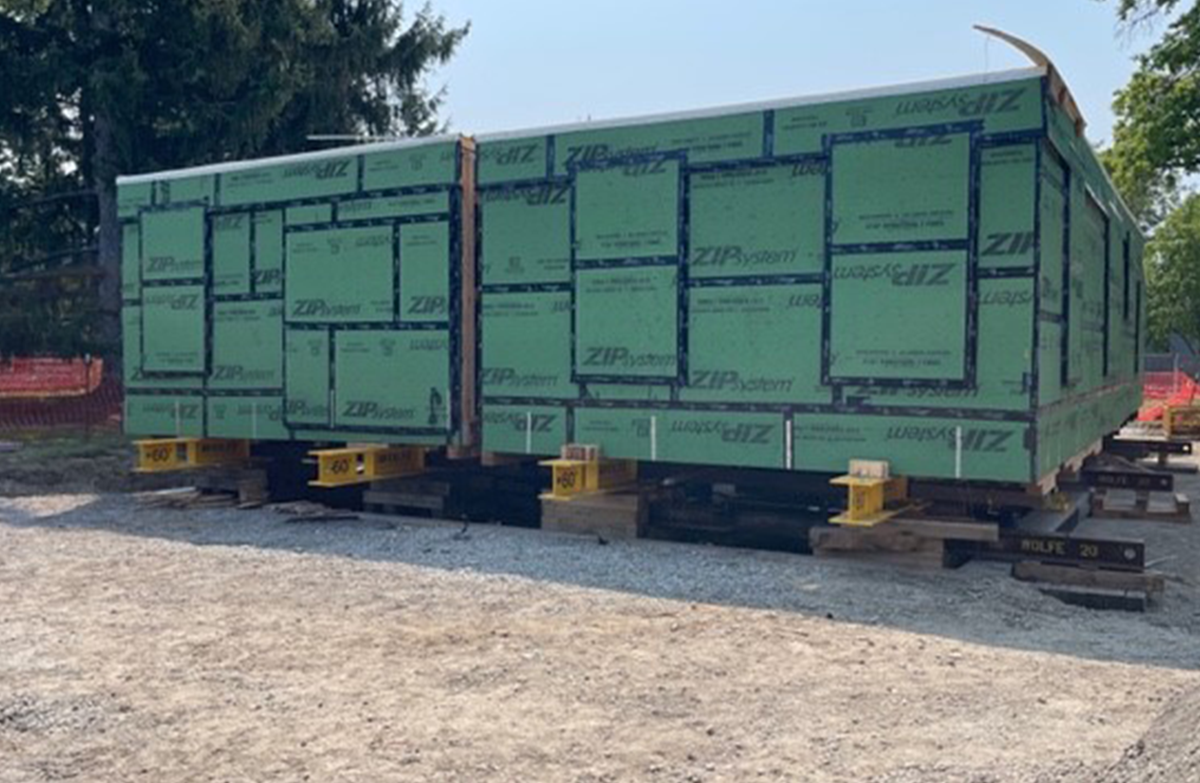 One half of The Jackson Home in its shipping container arriving at Greenfield Village and its two halves reunited on its new foundation. / Photos by Staff of The Henry Ford