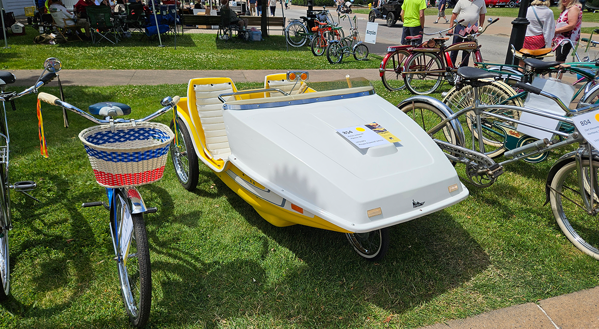 The two-seat yellow and white vehicle seen here was branded a PPV — a people-powered vehicle